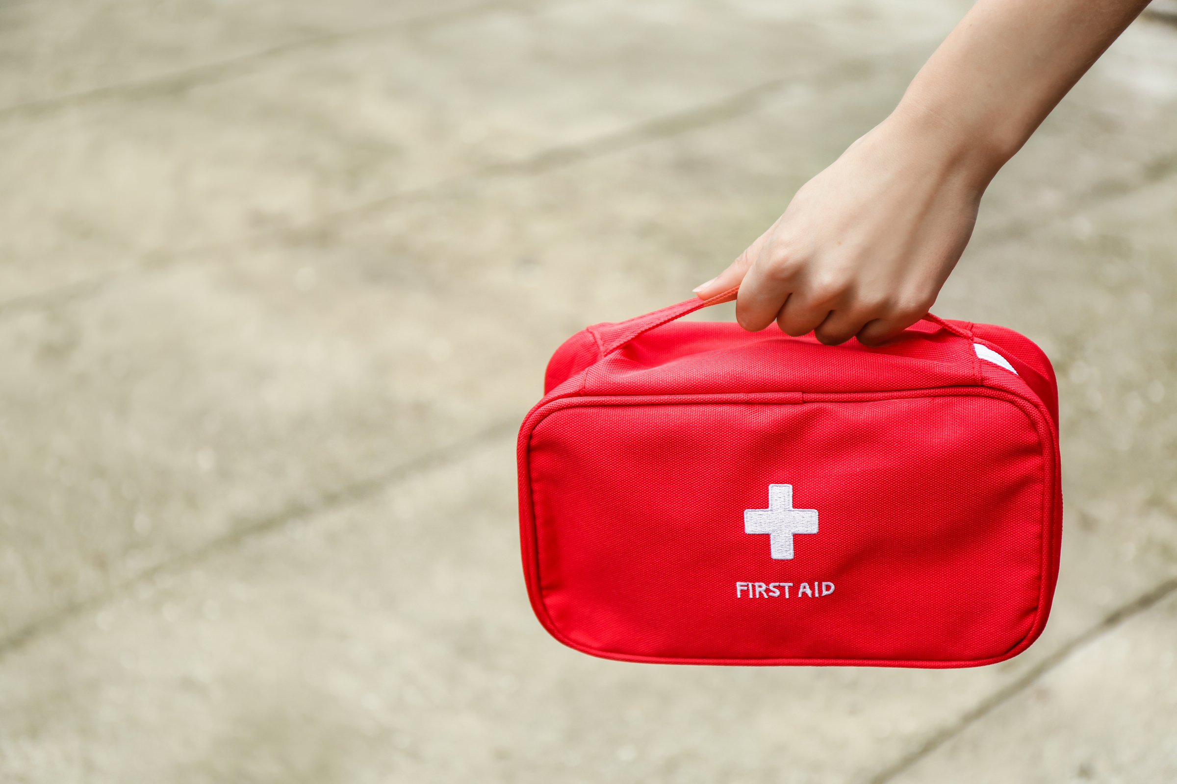 Woman with first aid kit outdoors